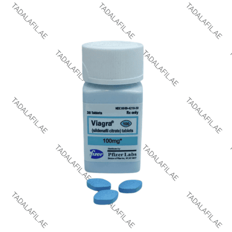Viagra 100mg bottle and blue tablets on white background